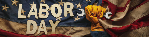 istock Old US American flag held by a worn work glove holding a crescent wrench with Labor day text. Labor day and American blue collar worker concept. 2165014436