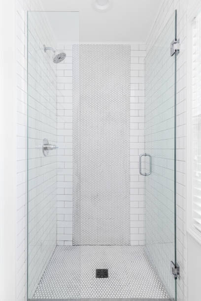 istock A bathroom shower with white subway and circular tiles. 2165015815