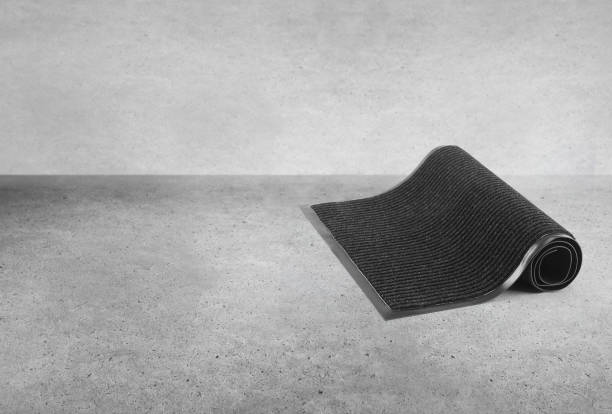 istock Rolled black protective door mat in a basement 2165015836
