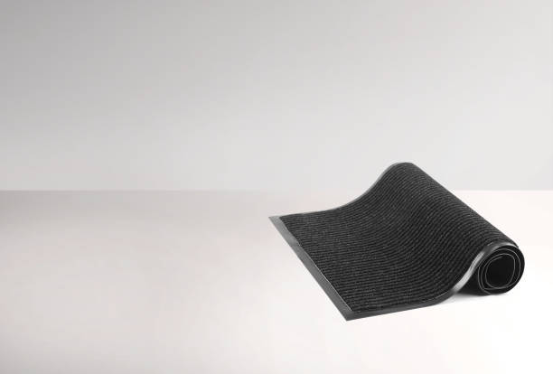 istock Rolled black protective door mat on a white background 2165015839