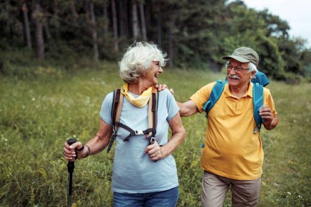 istock Cheerful senior couple hiking together in forest 2165018199
