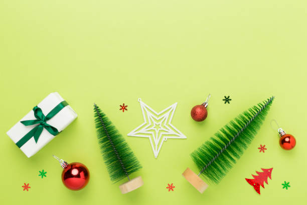 istock Small christmas tree with decor on color background, top view 2165019380