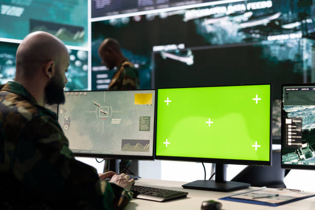 istock Army soldier working with a green screen next to satellite imagery 2165021560