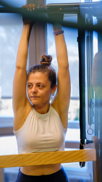 istock A middle-aged woman exercising on a Reformer Pilates machine 2165022929