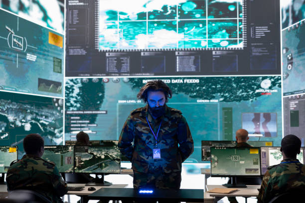 istock Army officer analyzing surveillance data on a hologram projection 2165023427