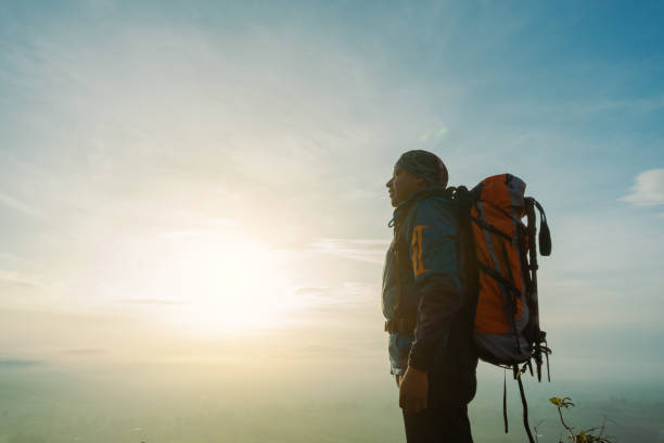 istock Man Standing, Contemplating the Dawn on the Mountain Top 2165024270