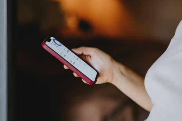 istock Close-Up Of Person Using Smartphone With App Open 2165024738