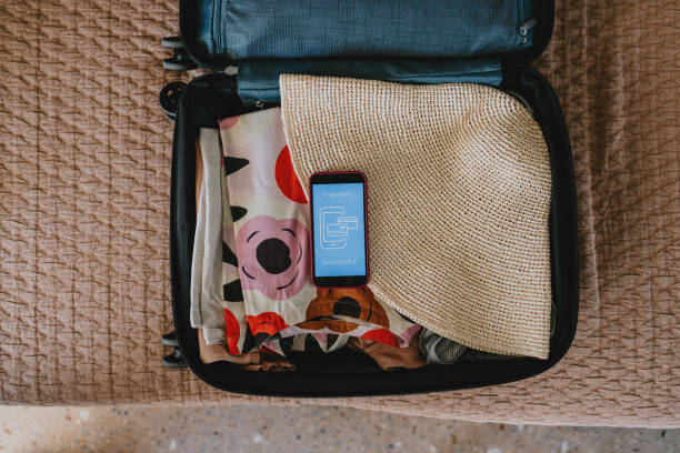 istock Packed Suitcase with Smartphone Showing Payment Successful Message 2165024791