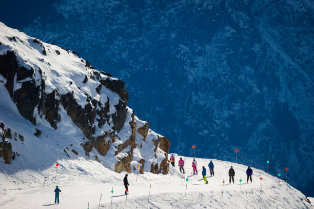Young boy skiing with a gondola in the background on a sunny day in the ski resort St .Anton am Arlberg, Austria