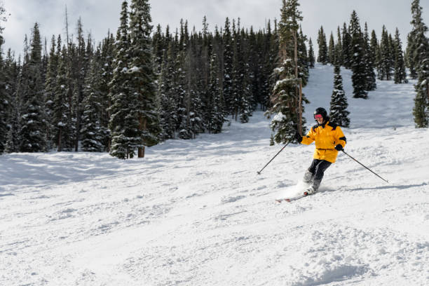 istock Man in Yellow Skiing Elegantly Downhill 2165025108