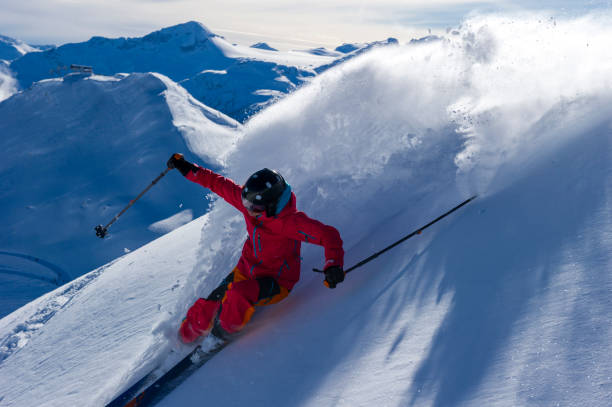 istock Skier skis down slope through fresh powder snow 2165025192