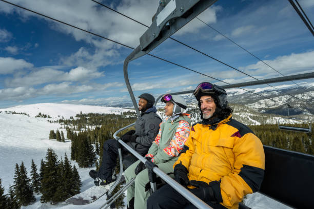 istock Smiling Skiers Riding Lift 2165025216