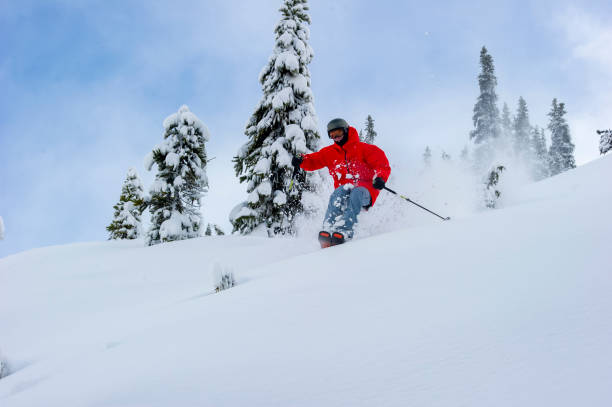 istock Skier skis down slope through fresh powder snow 2165025240