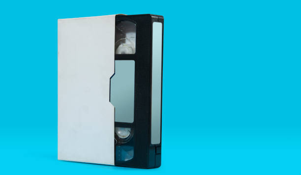 istock old black plastic VHS video cassette with white case on a blue surface against blue background 2165025324