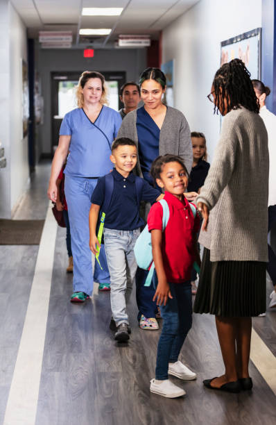 istock Parents dropping children off at elementary school 2165040744