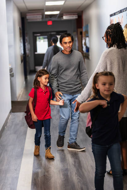 istock Asian father dropping daughter off at elementary school 2165040751