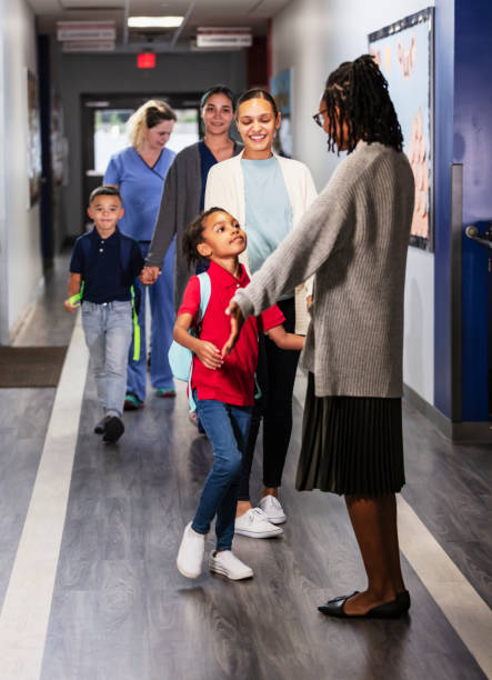 istock Mothers dropping children off at elementary school 2165040754