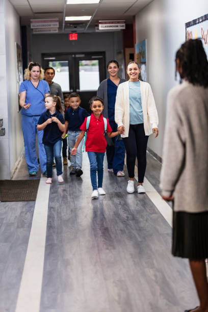 istock Parents dropping children off at elementary school 2165040758