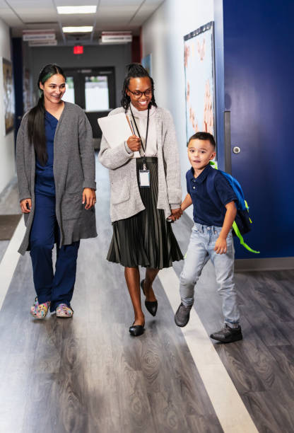 istock Hispanic mother in scrubs brings son to elementary school 2165040798
