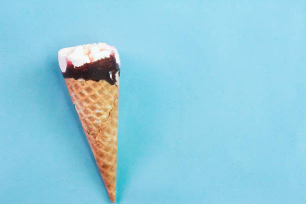 istock an ice cream cone on a blue background 2165046789