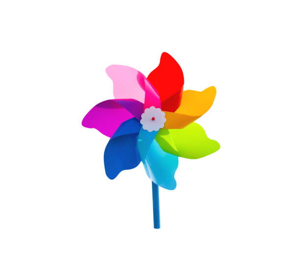 Close up view of multi colored pinwheels shot against blue sky with sun shining