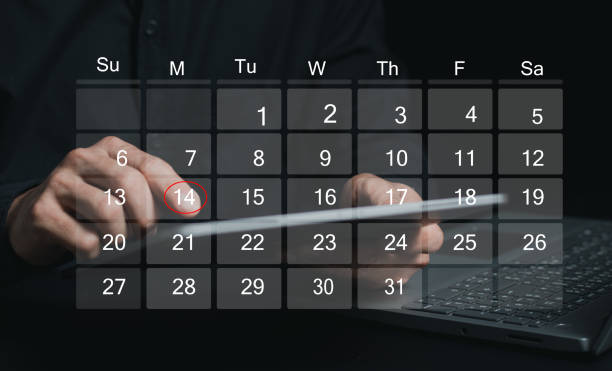 istock Time management concept. Businessman manages time for effective work. Calendar on the virtual screen interface. Highlight appointment reminders and meeting agenda on the calendar. 2165049521