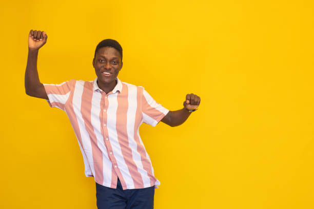 istock Smiling young man on the yellow background 2165049576