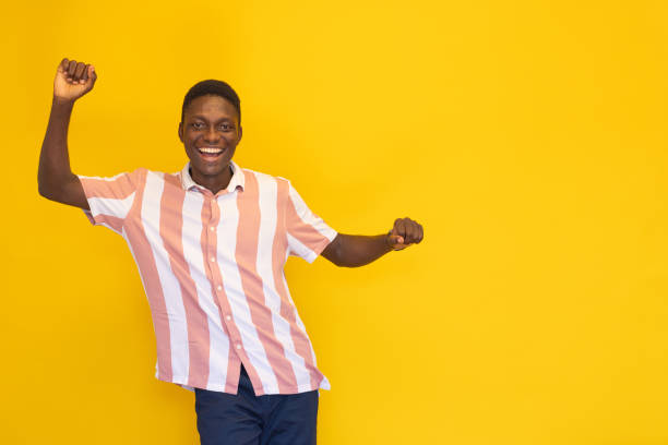 istock Confidence young man on the yellow background 2165049712