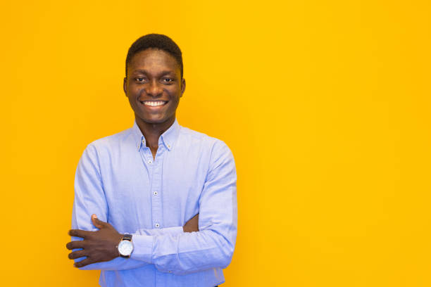 istock Smiling young man on the yellow background 2165050664