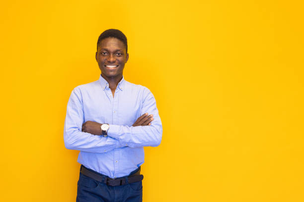 istock Smiling young man on the yellow background 2165051767