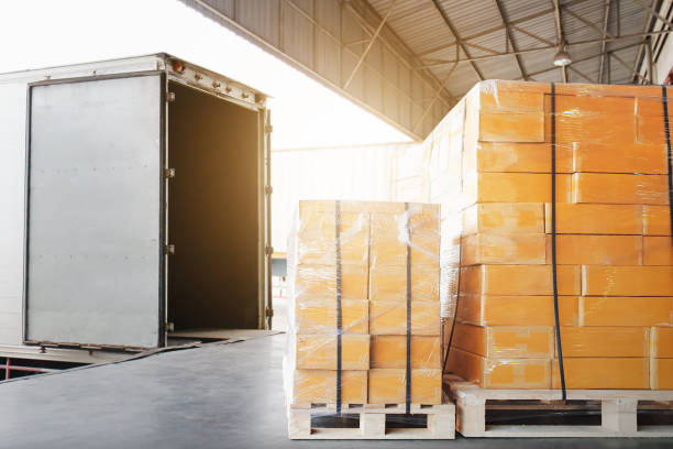 istock Bulk Pallets of Packaging Boxes Being Loaded onto a Container Trucks. Distribution Warehouse Container Transport, Supply chain, Parcel Delivery. Freight truck, Logistics, Transportation. 2165052067