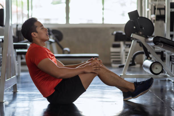 istock fit young Asian man doing workout and sit up in gym 2165052538