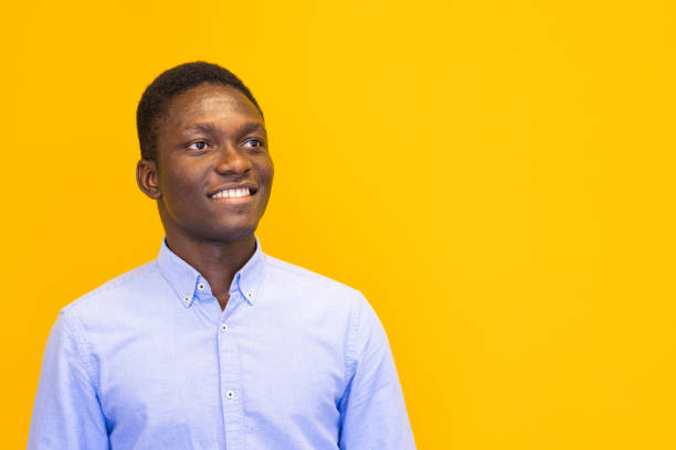 istock Smiling young man on the yellow background 2165052976