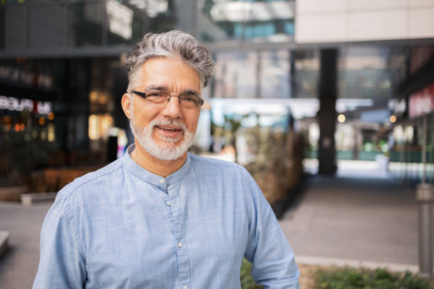istock Happy mature caucasian man smiling in an urban outdoors setting 2165053822