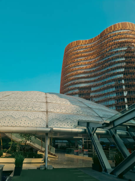 istock Modern office buildings exterior towering against blue sky. Office building viewed from below with dome shaped building next to it at Jakarta. 2165054180