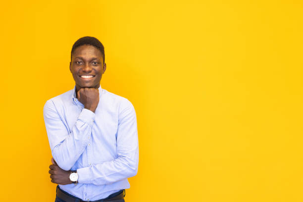 istock Smiling young man on the yellow background 2165054498
