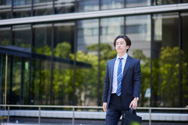 istock Young businessman in a suit leaving the office 2165054719