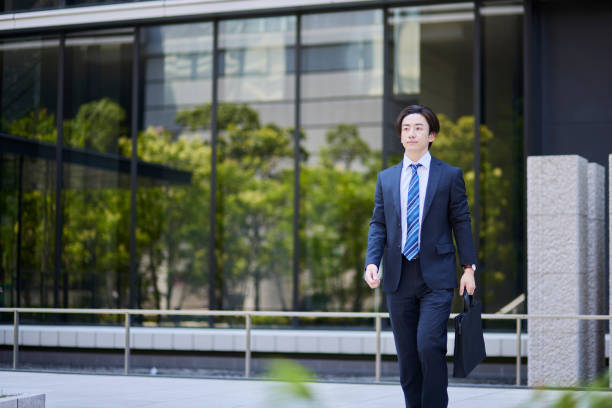 istock Young businessman in a suit leaving the office 2165054720