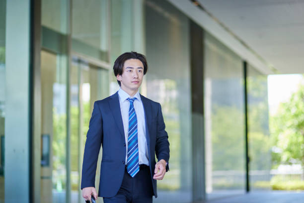 istock Young businessman in a suit leaving the office 2165054784