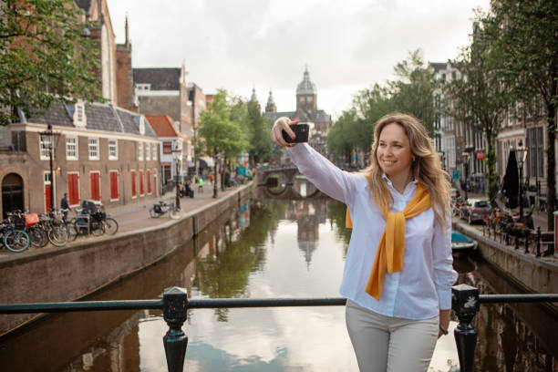 istock A middle aged woman sightseeing in Amsterdam 2165056070