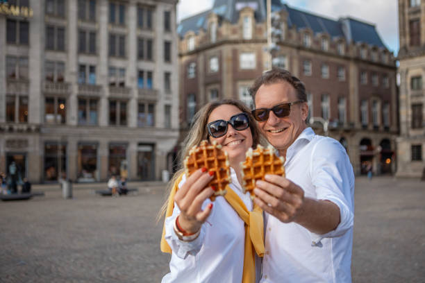 istock A middle aged couple enjoying waffles whilst sightseeing in Amsterdam 2165056334