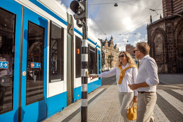 Amsterdam, the Netherlands - April 20, 2011: People boarding a tram in front of Amsterdam Central railway station. There are 16 tramlines in Amsterdam.