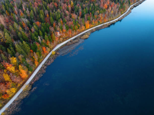 istock Aerial View On A Road By The Lake 2165056702