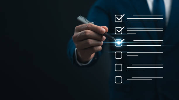 istock Performance checklist and tracking business performance, businessman using pen to mark checkboxes. 2165059128