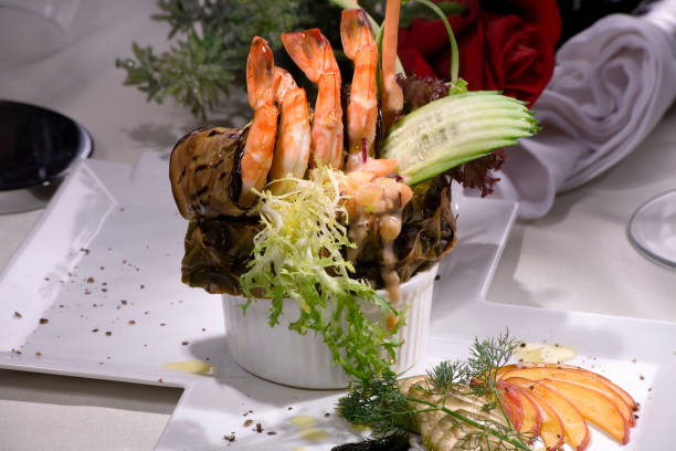 A table set with a variety of fish such as salmon and tuna, grilled meats including beef steaks and lamb chops, and white meats like roast chicken and duck à l'orange.
