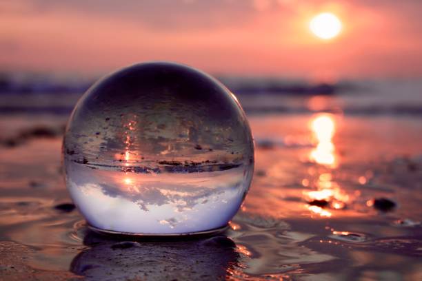 istock Crystal ball at the beach during sunrise 2165061095