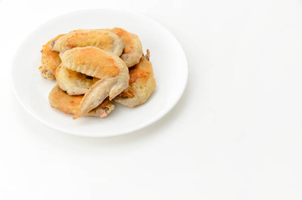 Exquisite Grilled Meat Rolls Garnished with Red Pepper and Lettuce on a White Plate