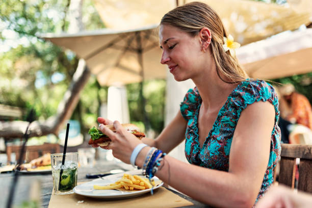 istock Young woman enjoying lunch in an outdoors restaurant 2165061990