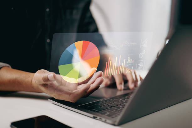 istock person using a laptop with floating pie charts and graphs. It represents data analysis, business intelligence, and the use of visual tools for better understanding and decision-making. 2165063289