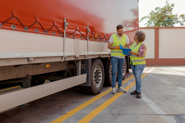 istock Truck Drivers Talk and Perform a Technical Inspection 2165069488